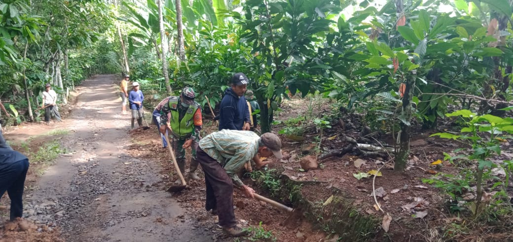 Bersama warga Serka Sahrul Bersihkan Parit Di Sepanjang Jalan